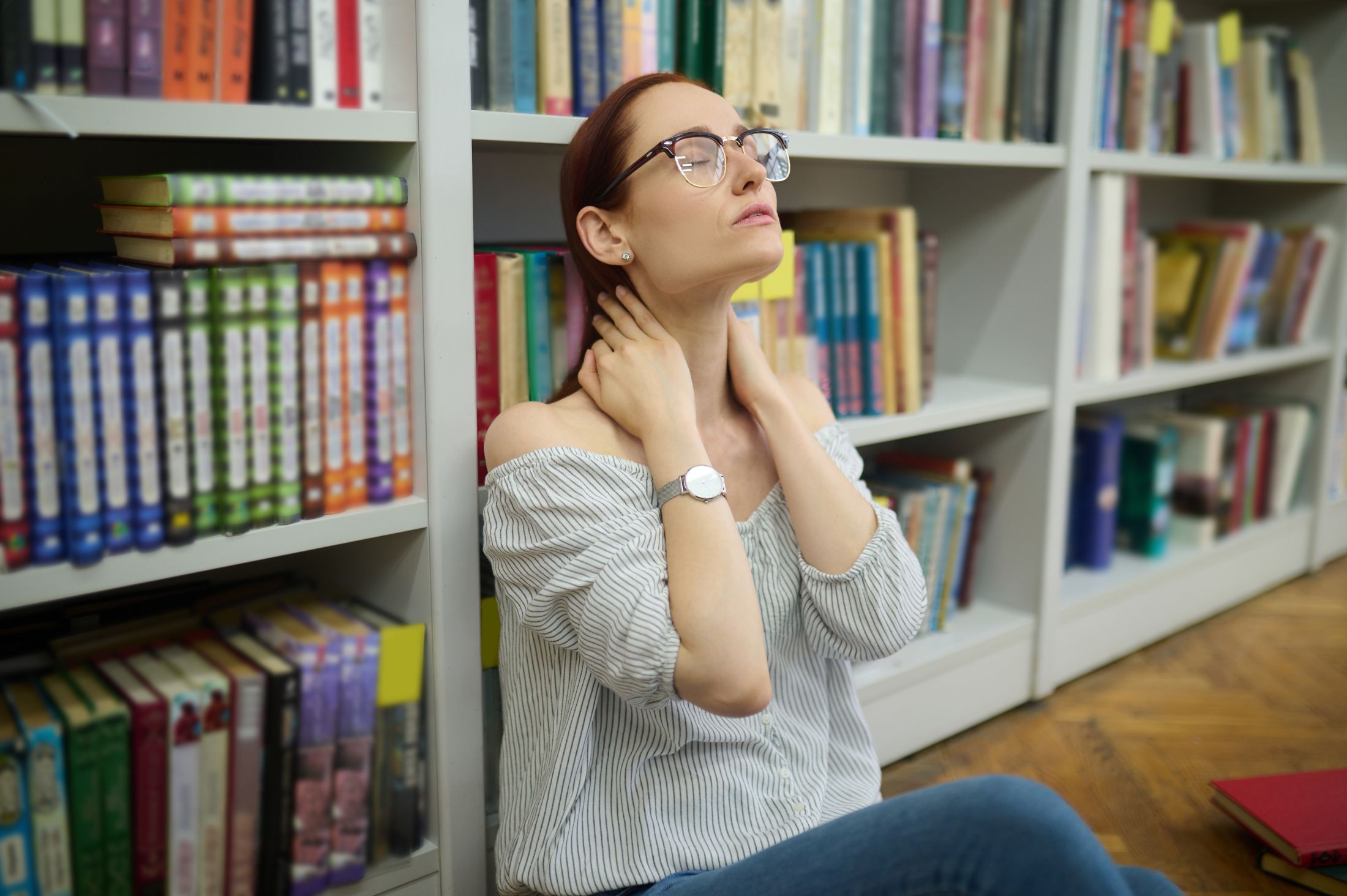 tired-woman-sitting-on-floor-near-bookshelves.jpg