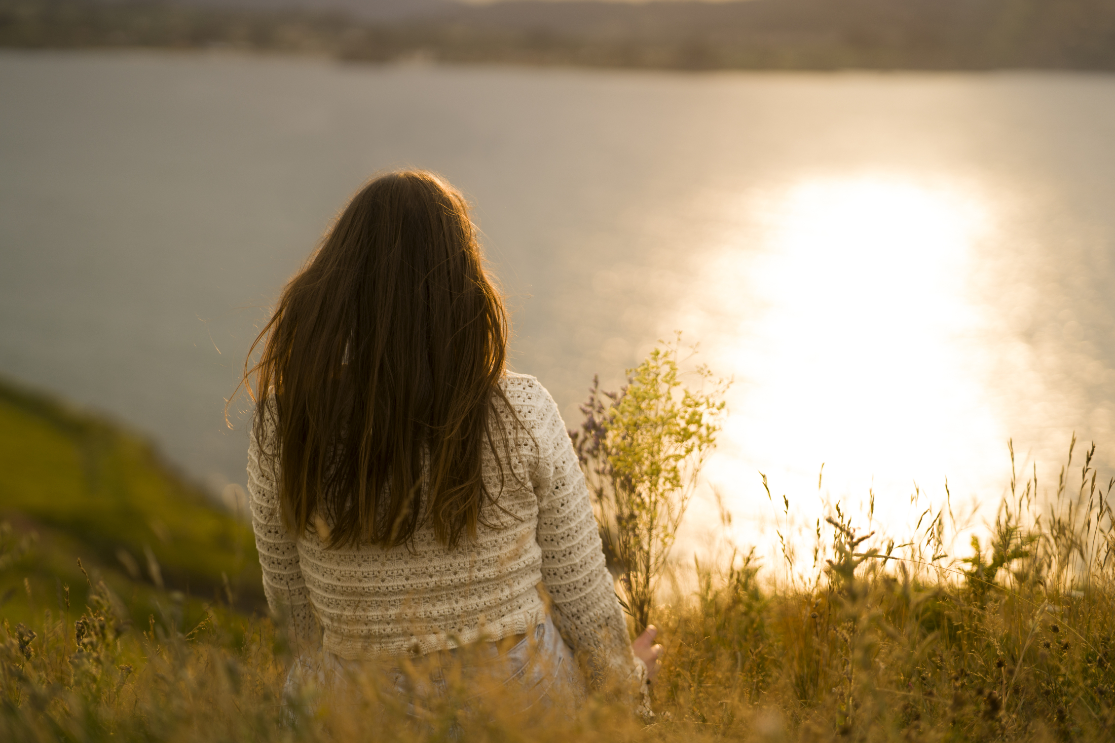 back-view-woman-sitting-by-lake.jpg