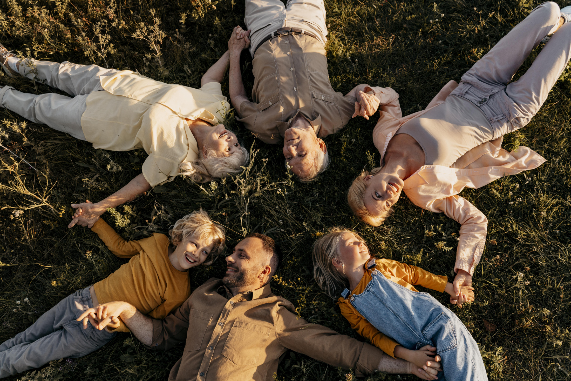 medium-shot-family-members-laying-grass.jpg