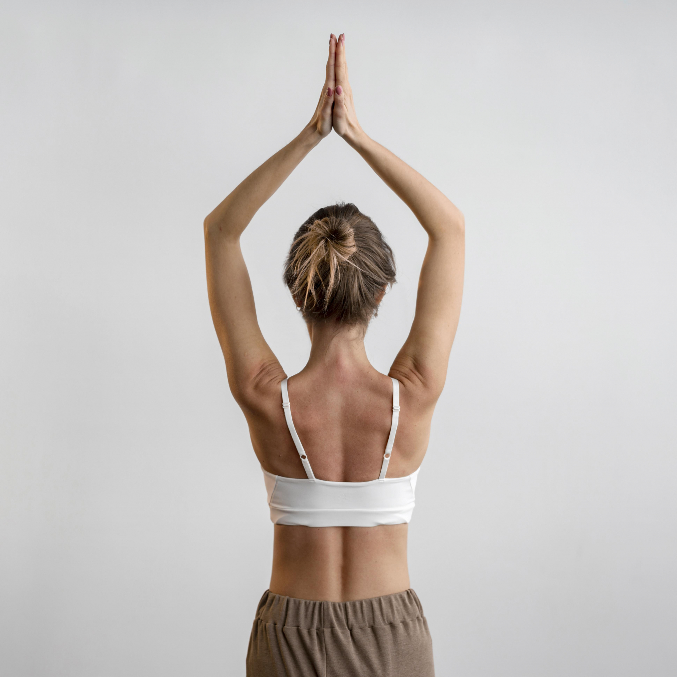back-view-of-woman-practicing-yoga-at-home.jpg