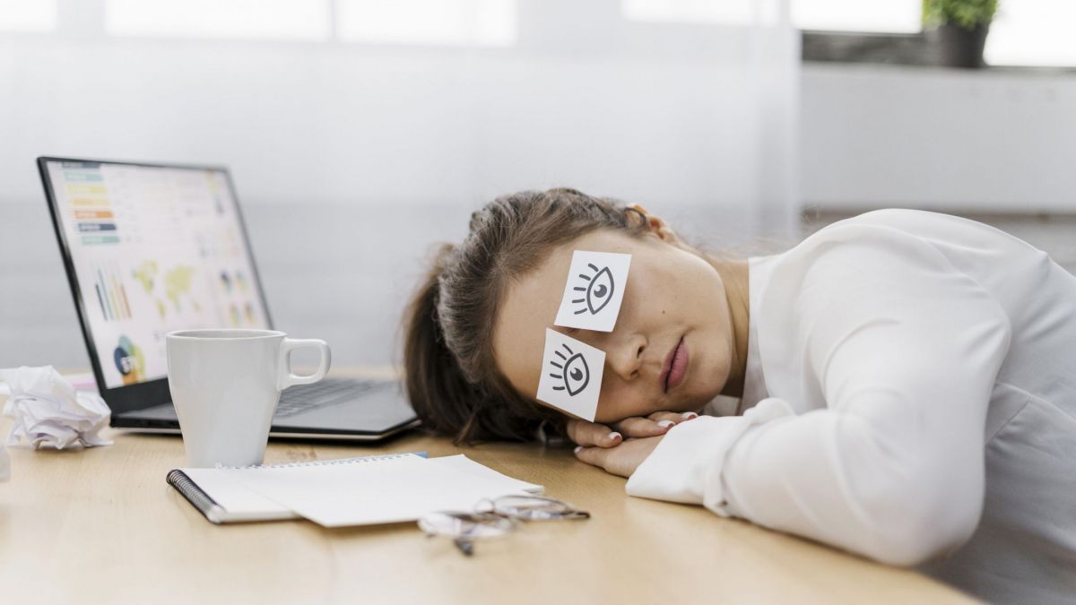 tired-businesswoman-covering-her-eyes-with-drawn-eyes-on-paper.jpg