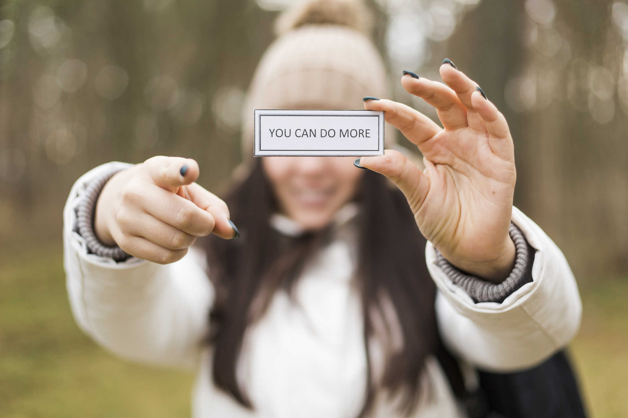 woman-with-inspirational-writing-pointing-camera.jpg