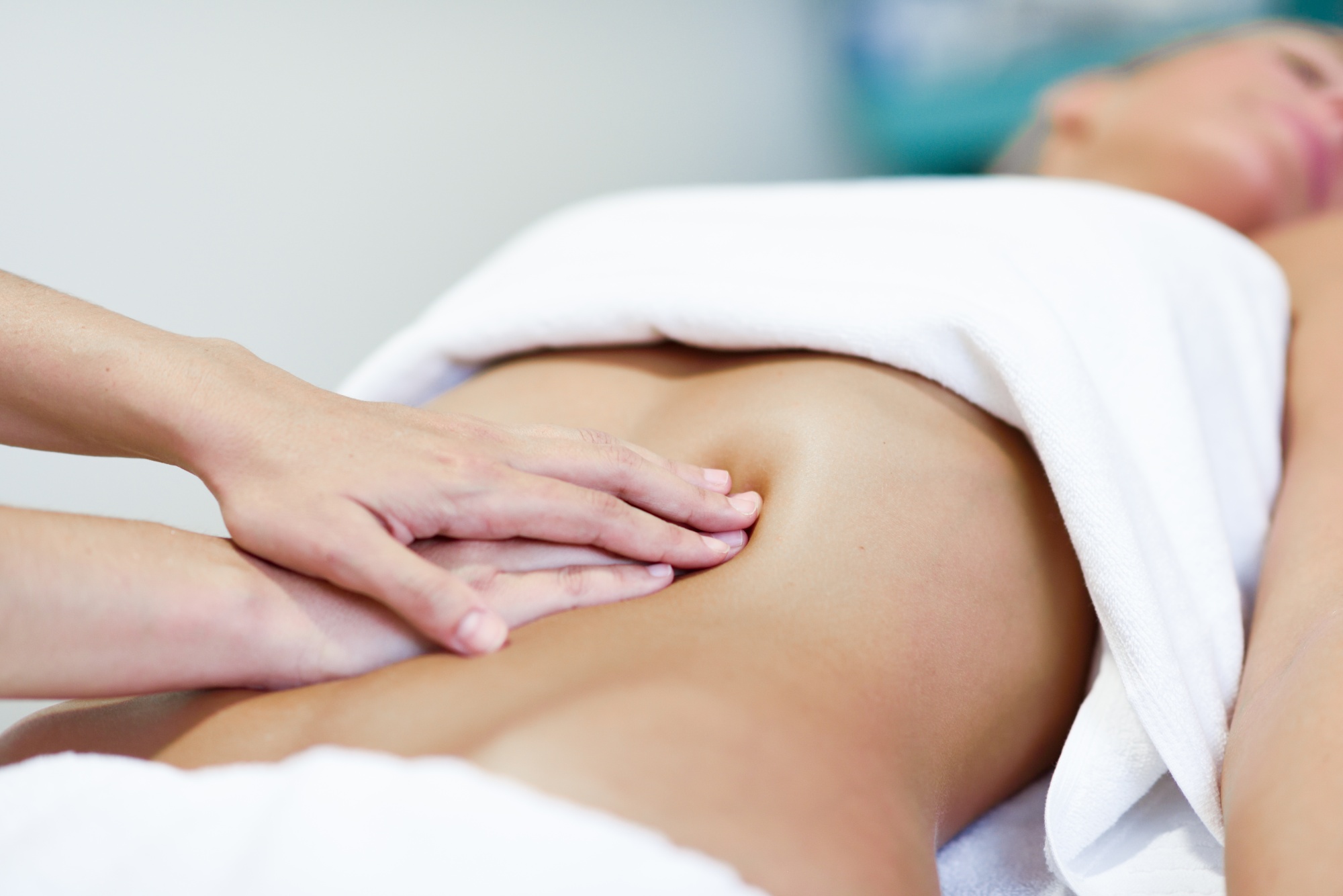 hands-massaging-female-abdomen-therapist-applying-pressure-belly.jpg