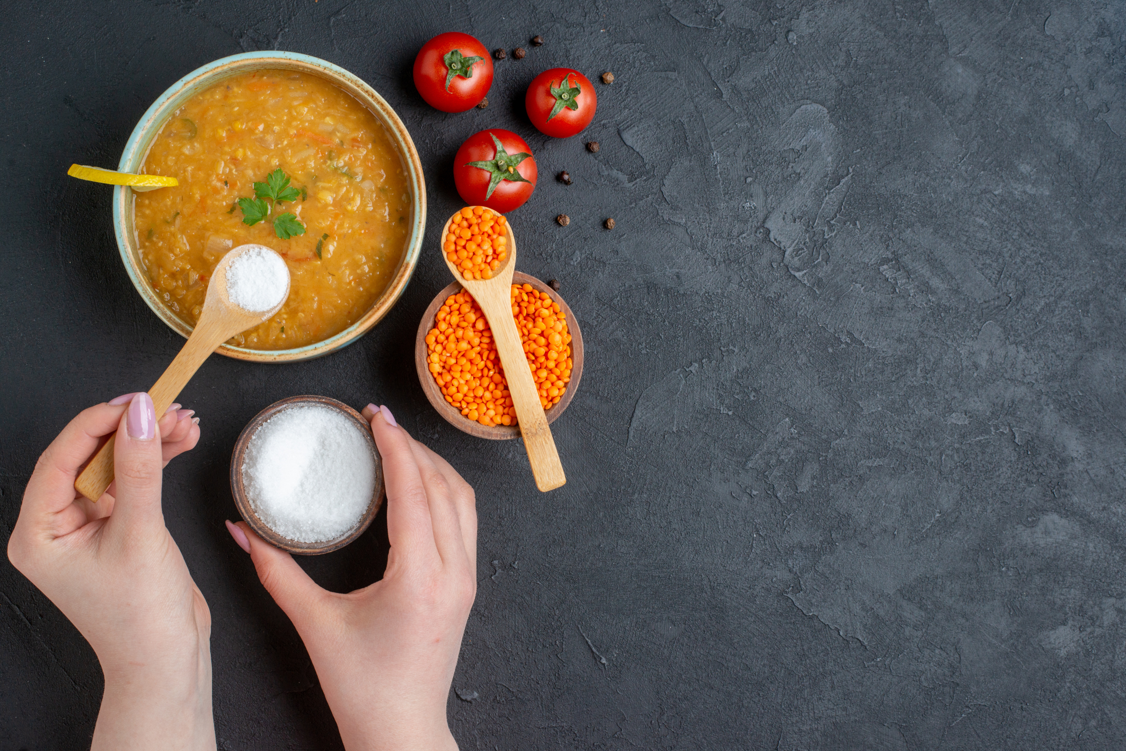 top-view-delicious-lentil-soup-with-female-whose-pouring-salt-into-her-soup-dark-surface.jpg