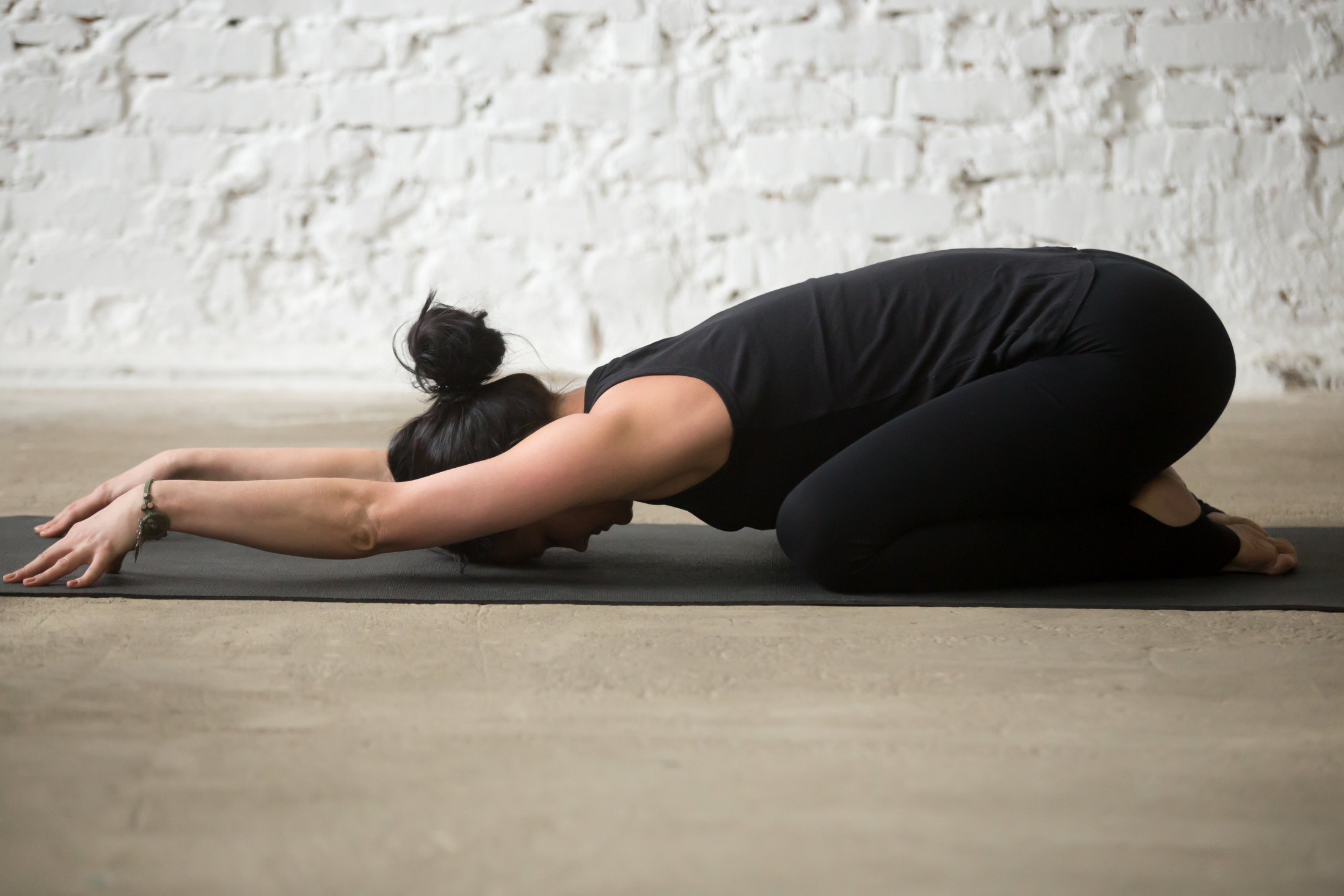 young-yogi-attractive-woman-child-pose-white-loft-background.jpg