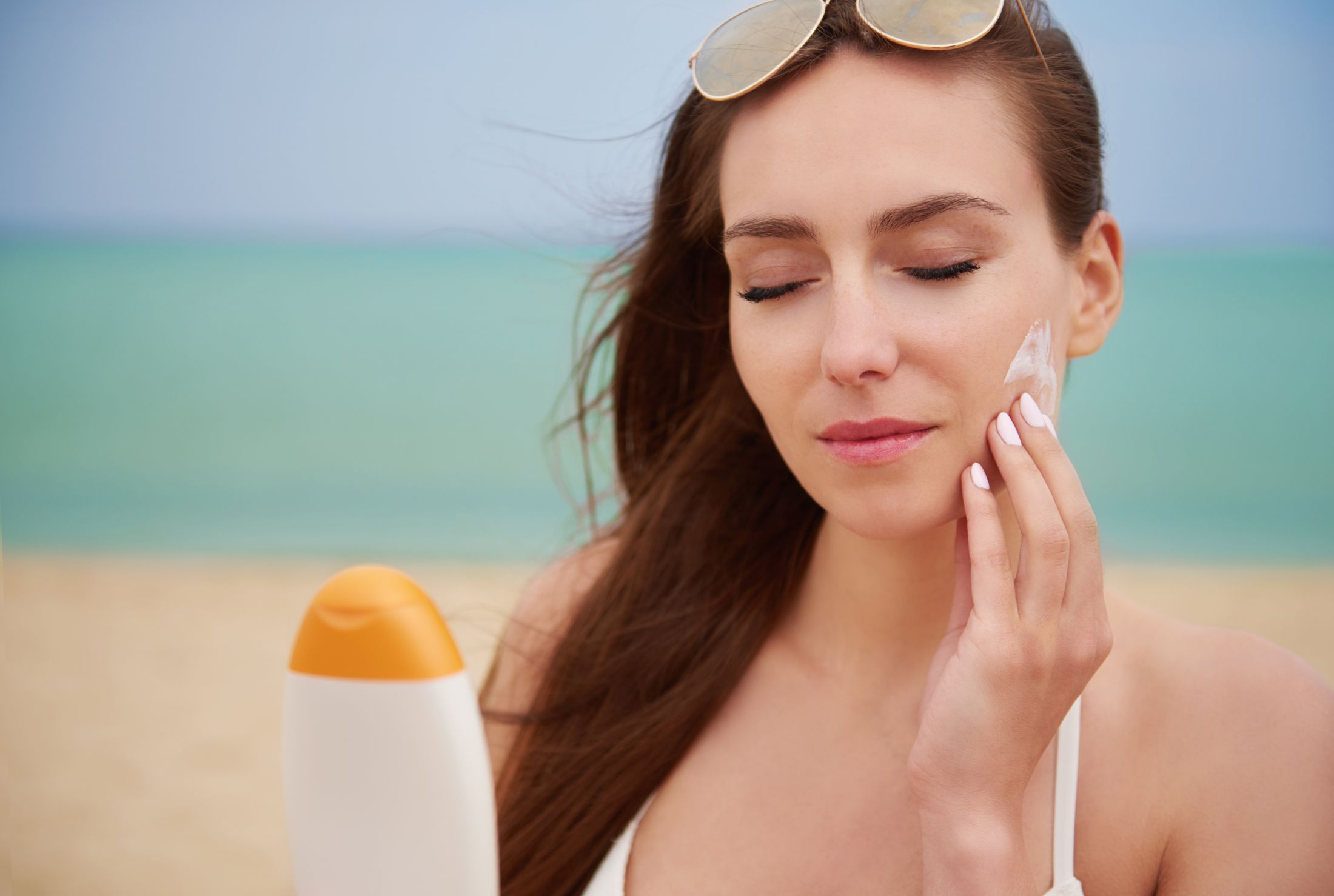 young-beautiful-woman-applying-sun-cream-beach.jpg