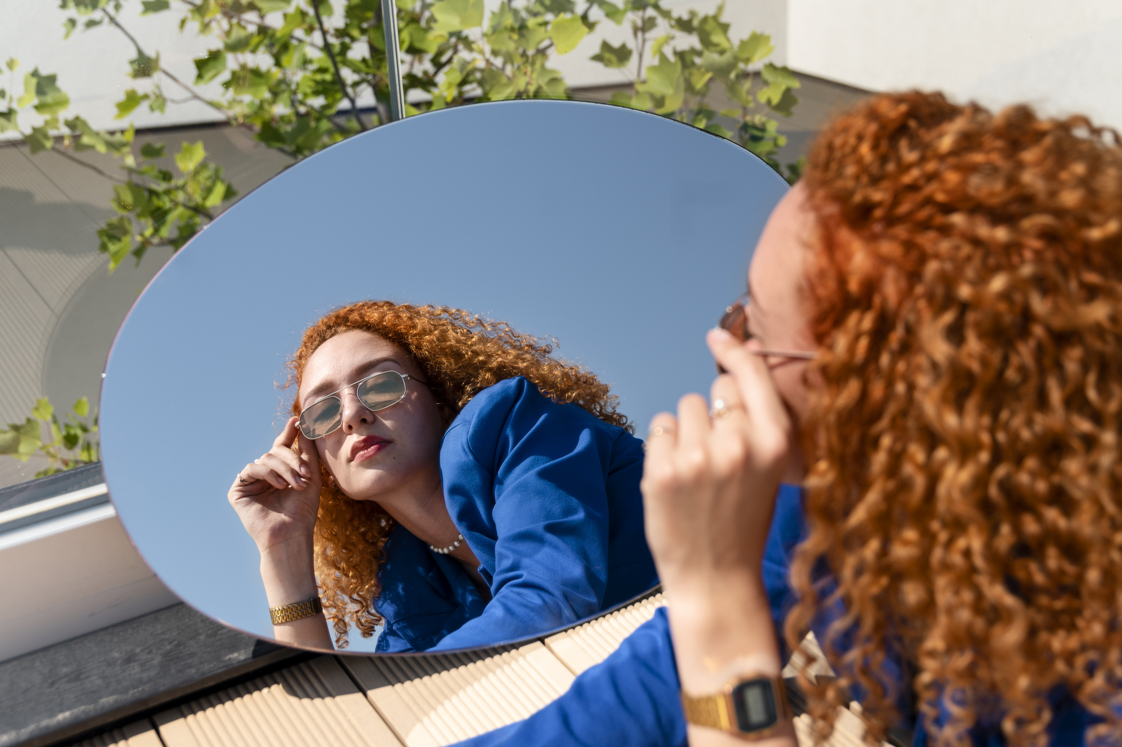 young-woman-blue-suit-posing-with-mirror-outdoors.jpg