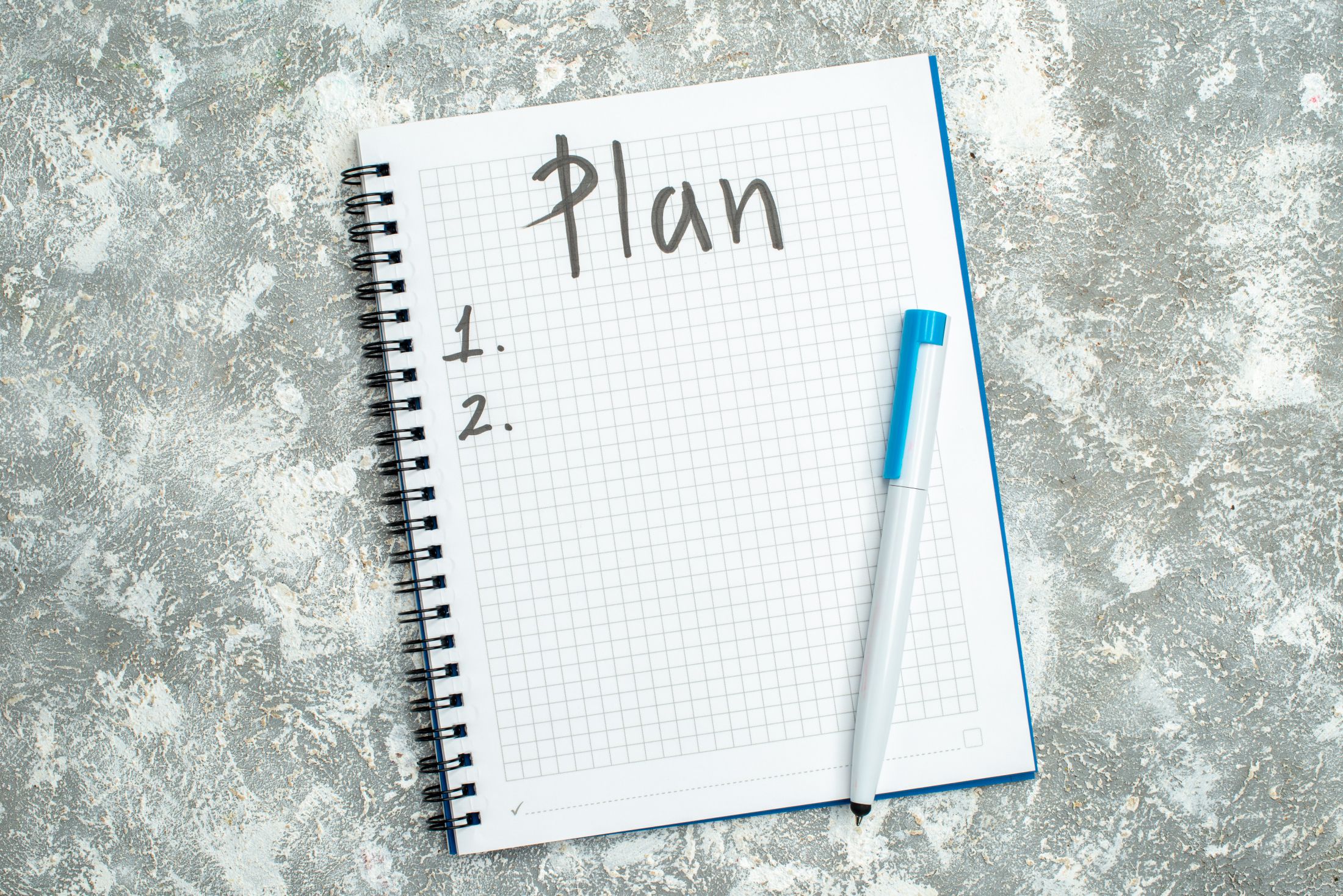 overhead-view-of-written-spiral-notebook-with-pen-on-gray-background.jpg