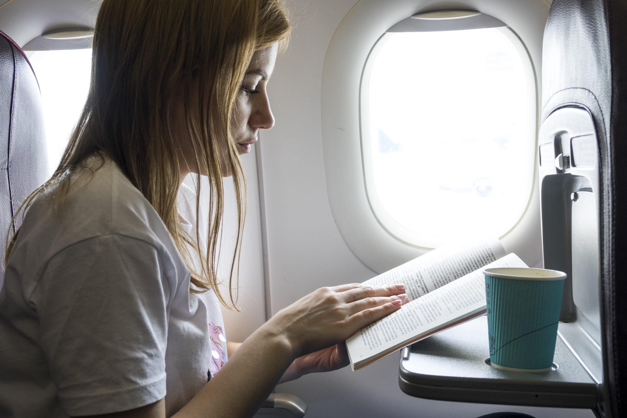 woman-reading-book-plane.jpg