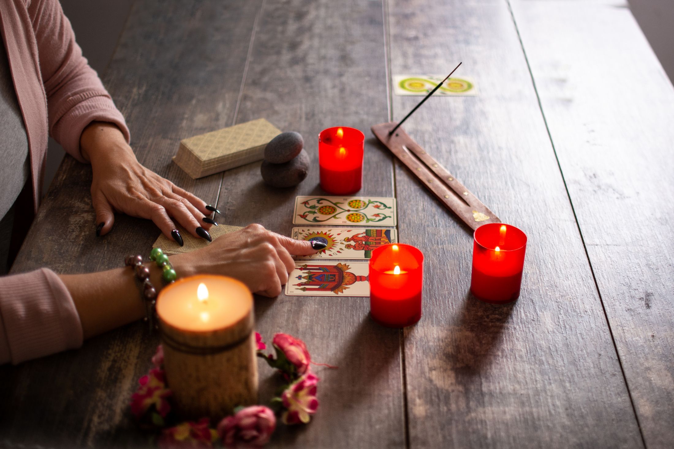 fortune-teller-reading-a-future-by-tarot-cards-on-rustic-table.jpg