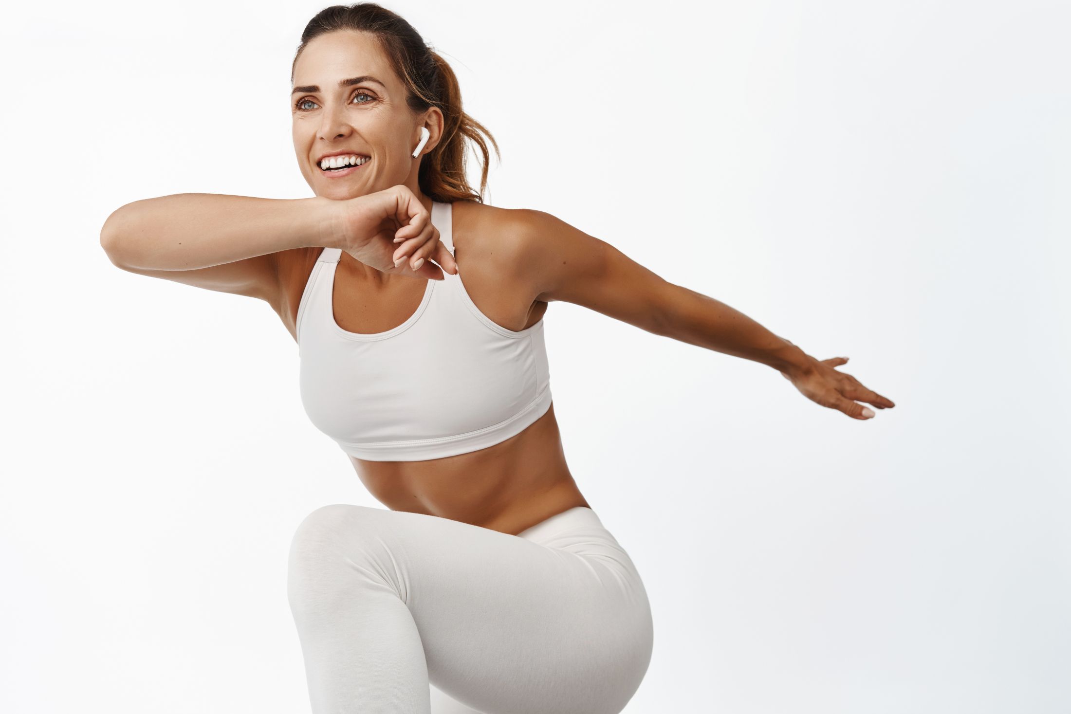 portrait-of-sportswoman-stretching-body-exercising-doing-fitness-leg-raise-and-smiling-running-standing-over-white-background.jpg