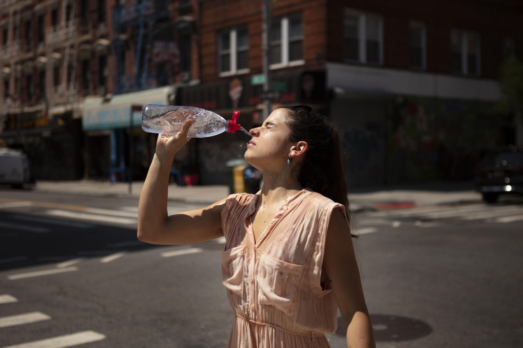 young-woman-tolerating-heat-wave-with-cool-drink.jpg