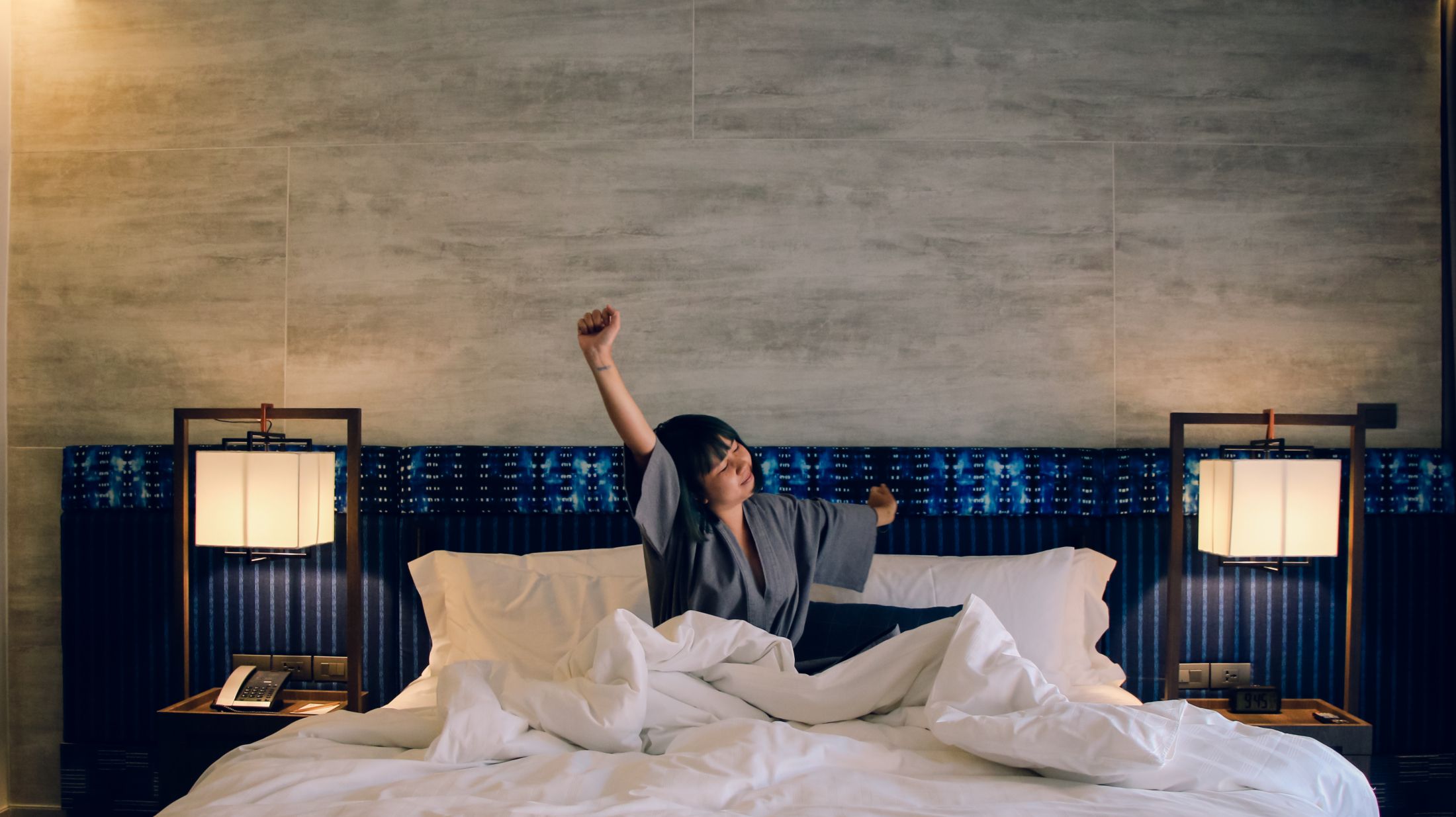 asian-women-wake-up-from-sleep-are-stretch-herself-in-the-morning-on-the-weekend-sit-on-the-bed-at-luxury-room-in-relax-and-weekend-concept.jpg