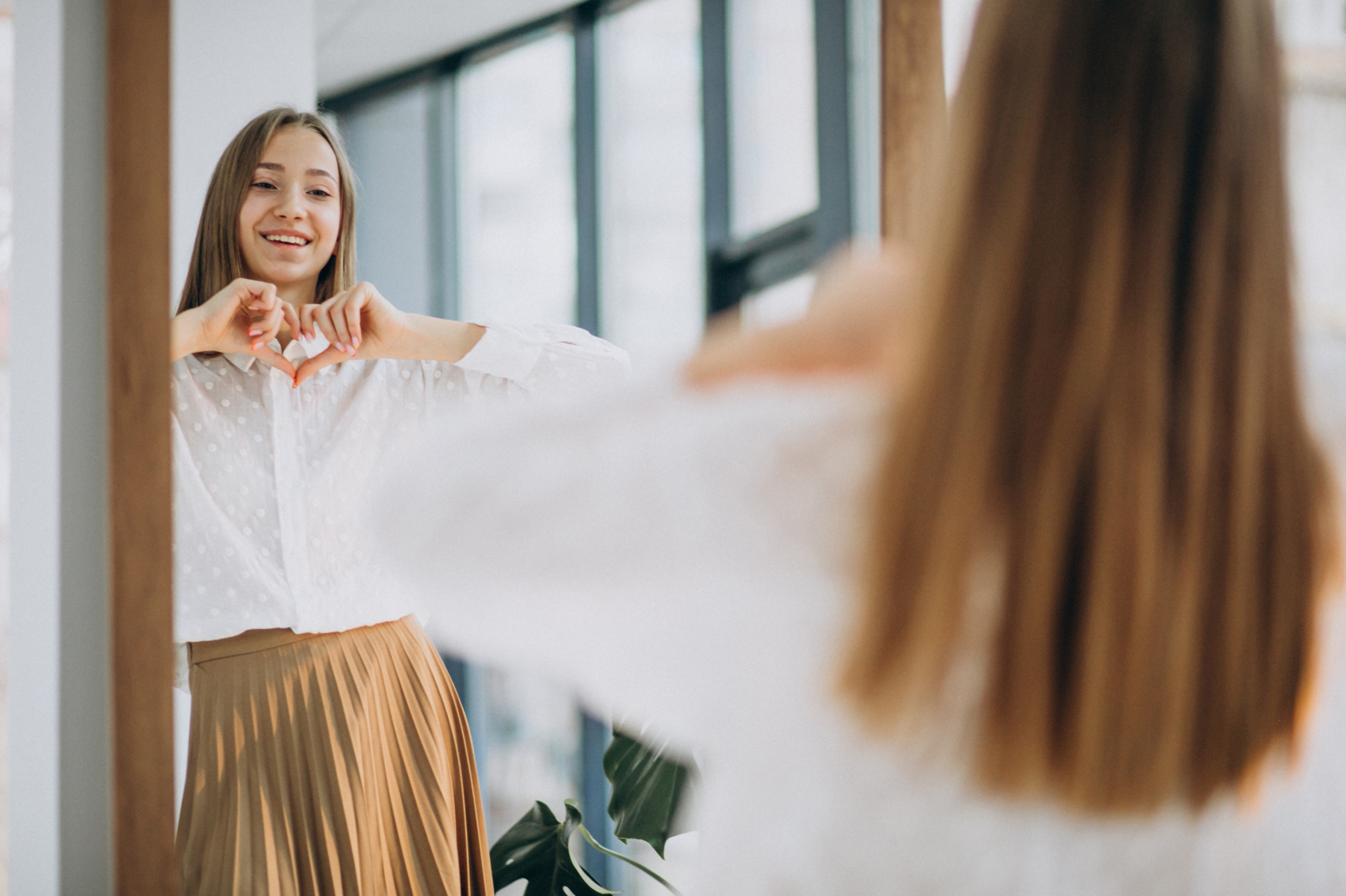 pretty-young-woman-casual-outfit-looking-into-mirror.jpg