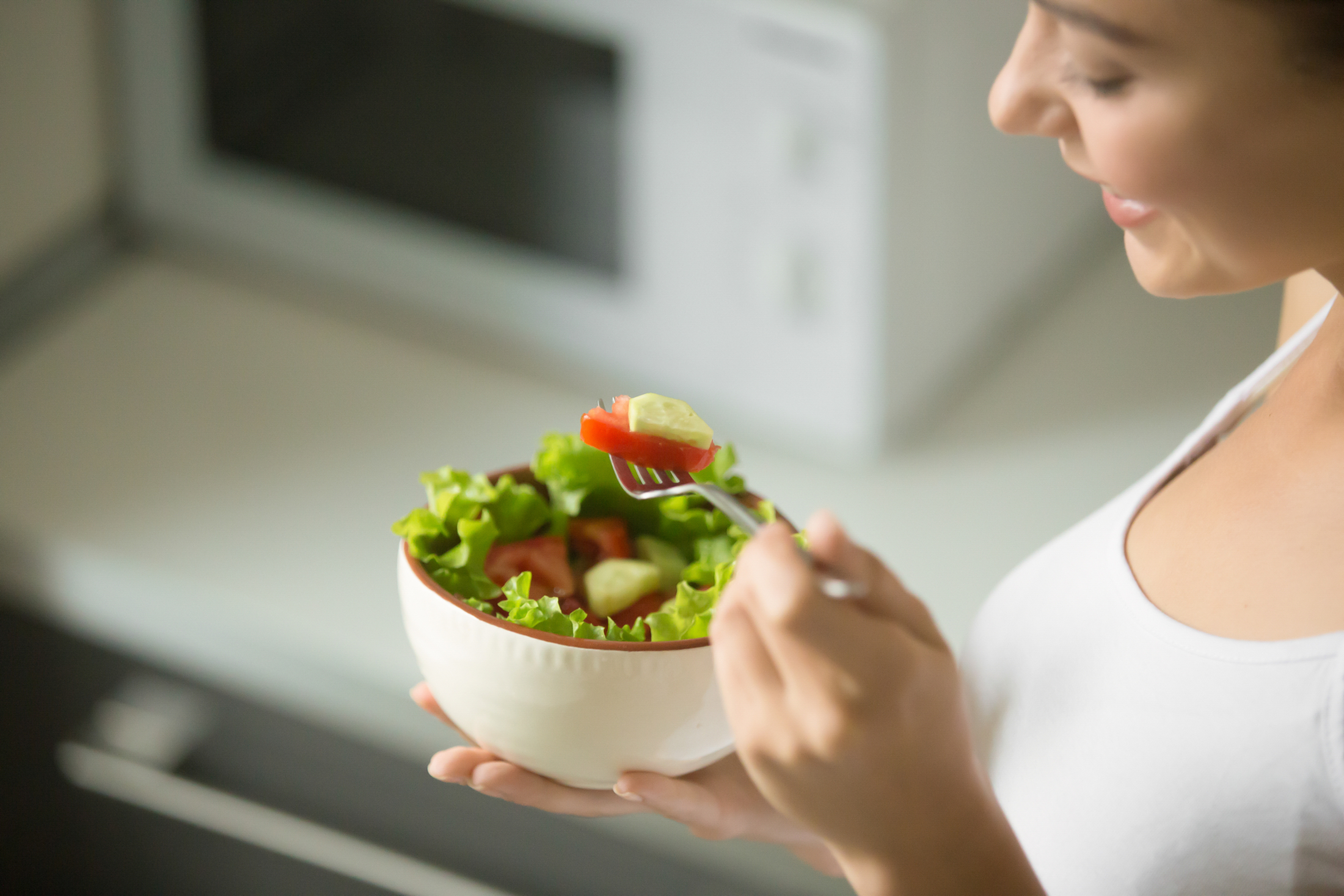 bowl-of-fresh-green-salad-hold-in-female-hands.jpg