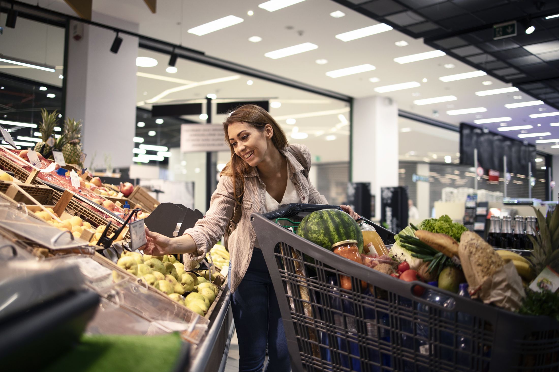 beautiful-female-person-checking-the-price-of-fruit-at-grocery-store.jpg