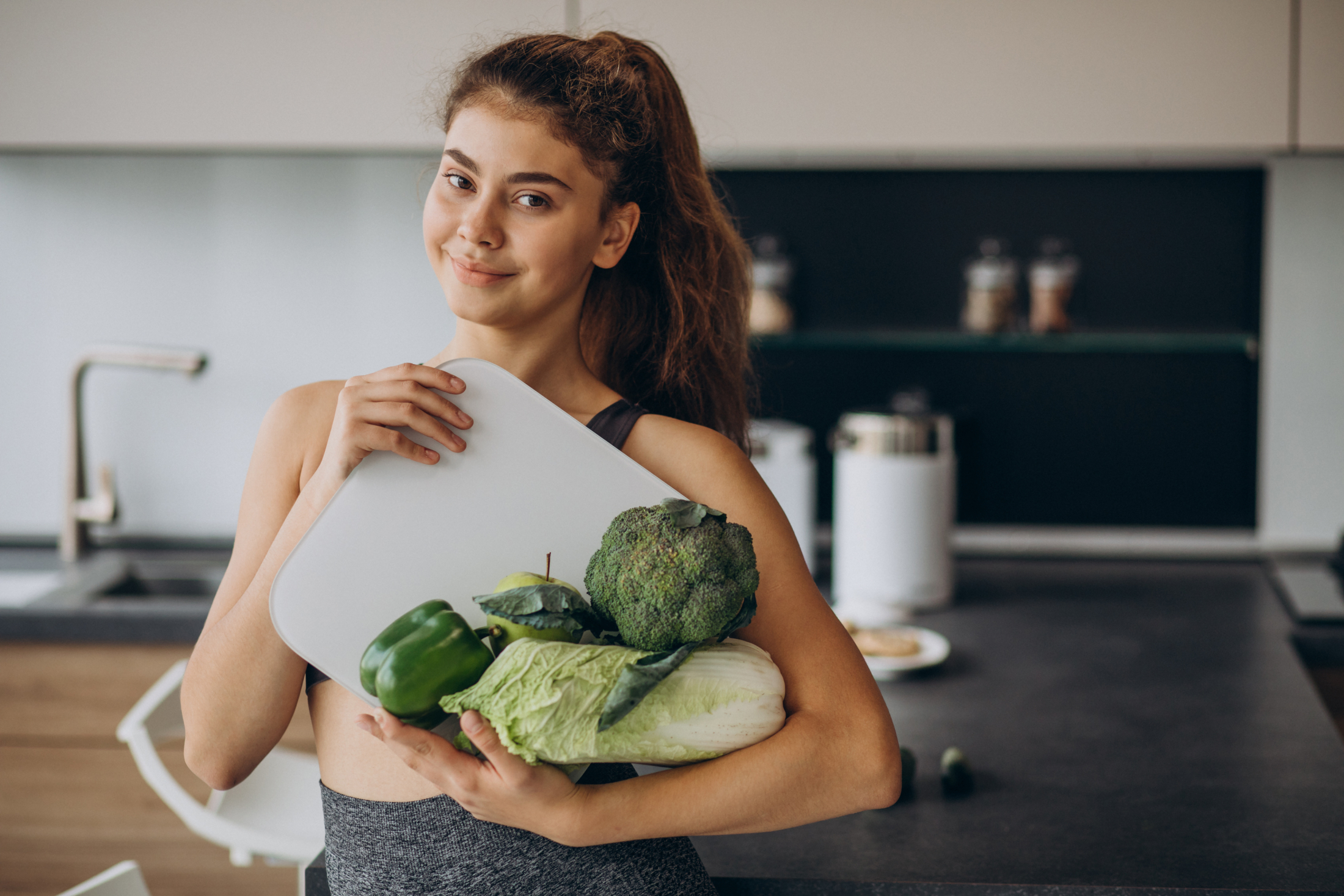 young-sporty-woman-with-scales-vegetables-kitchen.jpg