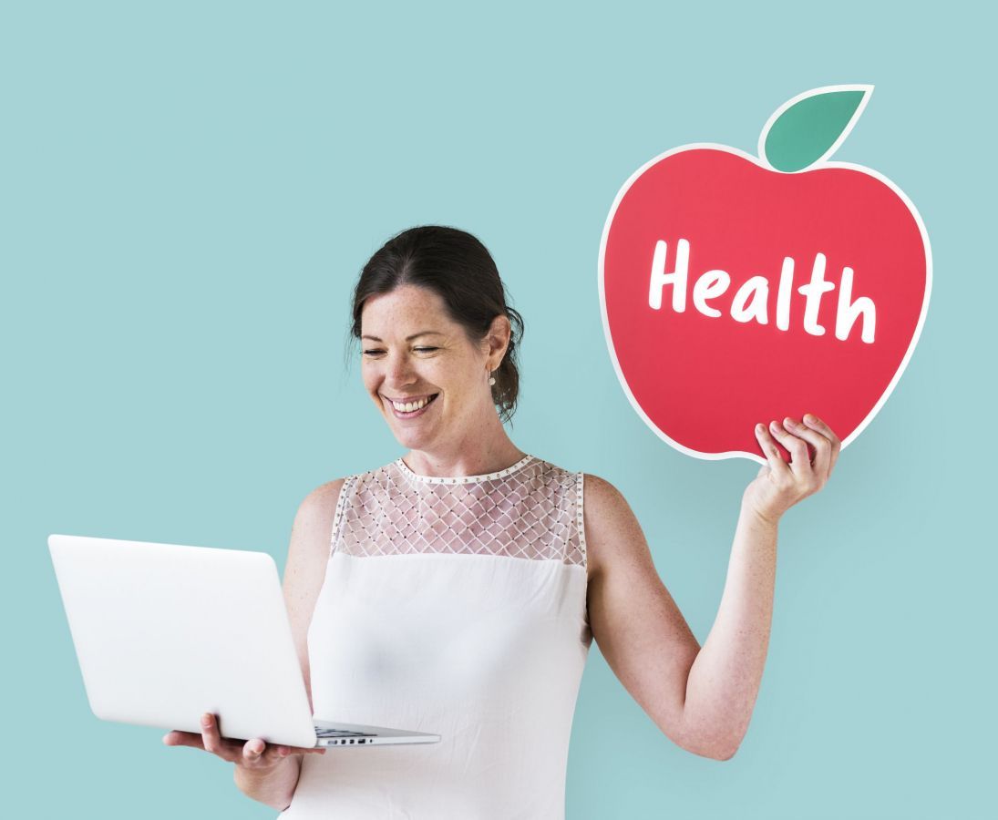 woman-holding-a-health-icon-and-using-a-laptop.jpg