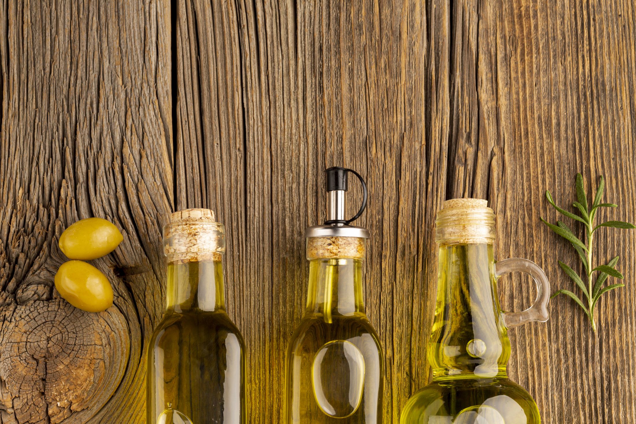 yellow-olives-oil-bottles-wooden-background.jpg
