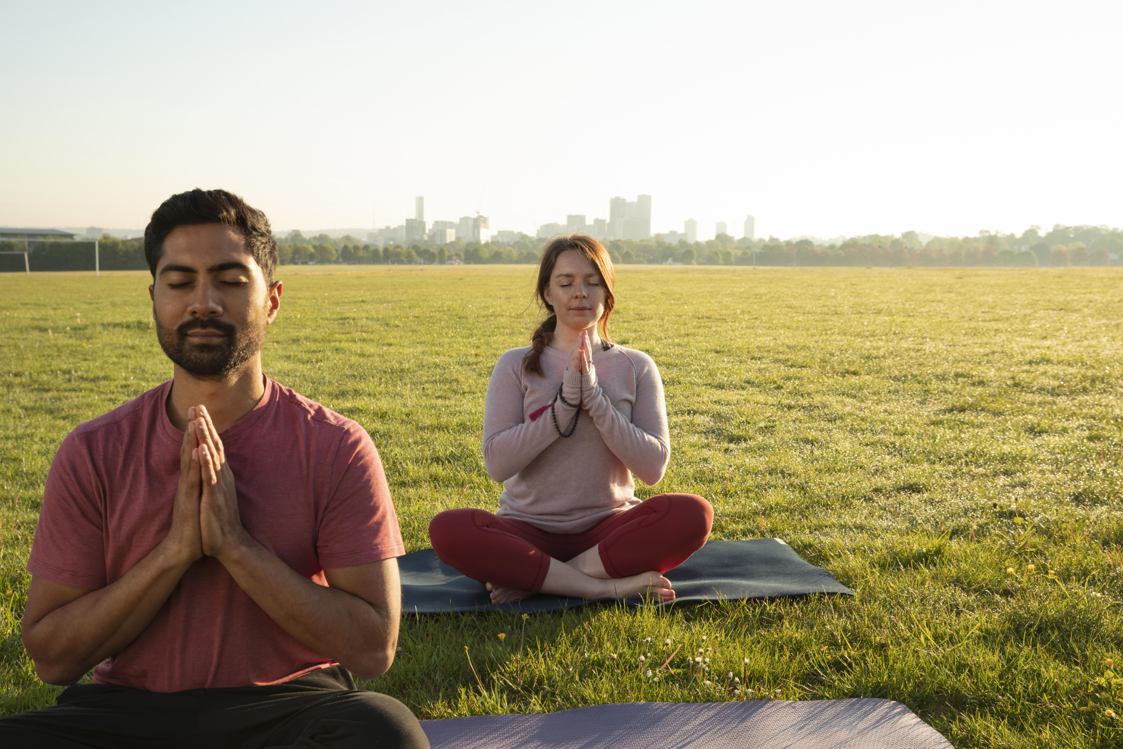 front-view-man-woman-meditating-outdoors-yoga-mats.jpg