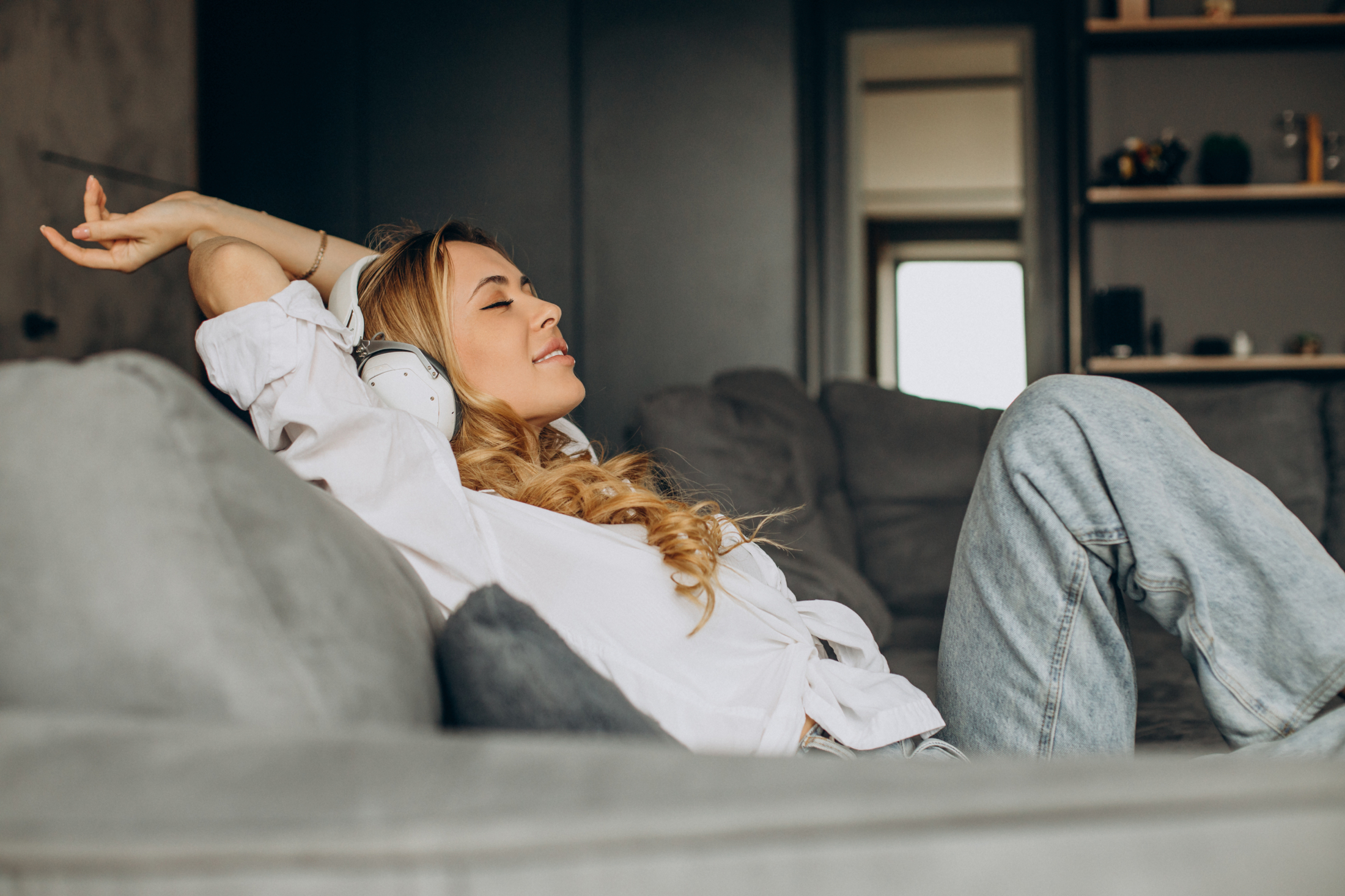 young-woman-listening-music-earphones-her-appartment.jpg