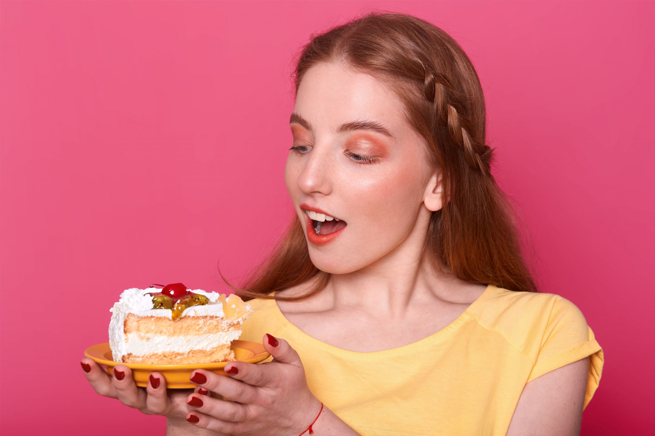 attractive-young-woman-with-opened-mouth-holds-plate-with-piece-delicious-cake-hands-brown-haired-lady-with-red-manicure.jpg