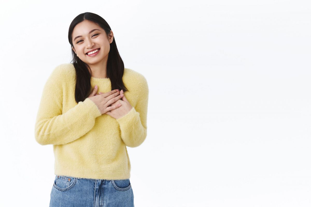 gorgeous-asian-cute-girl-in-yellow-sweater-press-hands-to-chest-laughing-and-smiling-shy-blushing-from-compliment-being-touched-by-praises.jpg