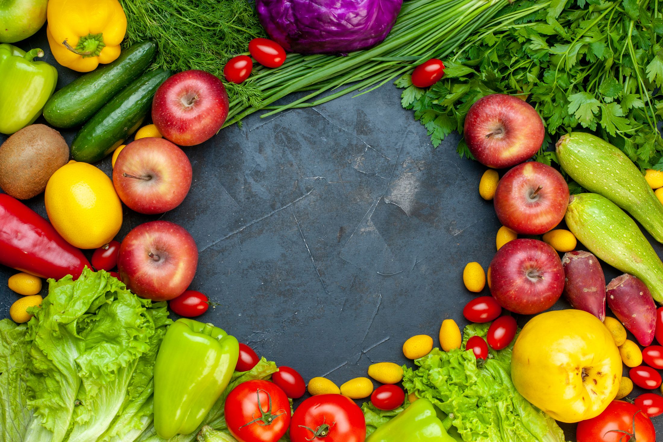 top-view-vegetables-and-fruits-lettuce-tomatoes-cucumber-dill-cherry-tomatoes-zucchini-green-onion-parsley-apple-lemon-kiwi-free-space-in-center.jpg