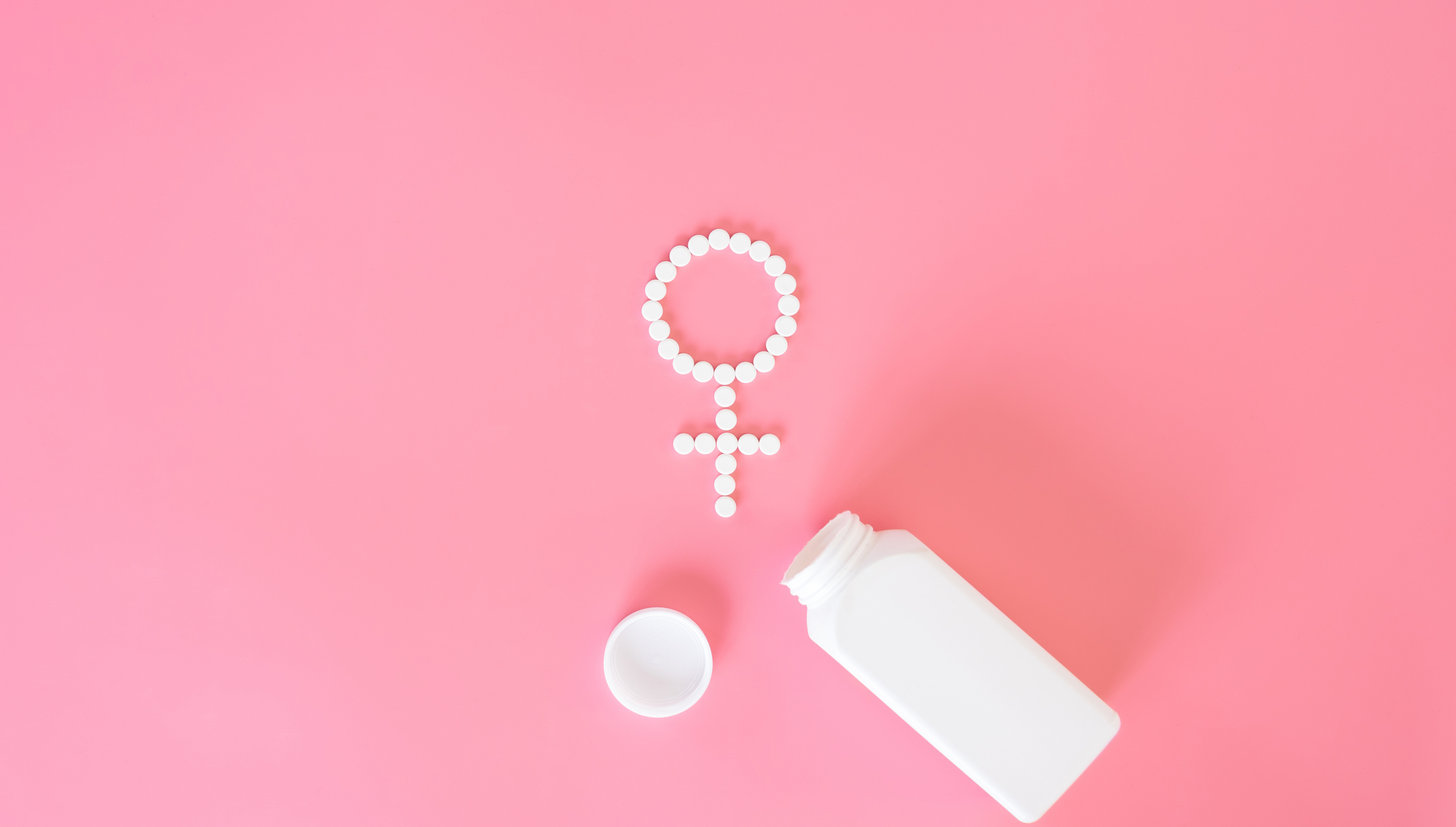 pills-on-a-pink-background-flat-lay-womens-health.jpg