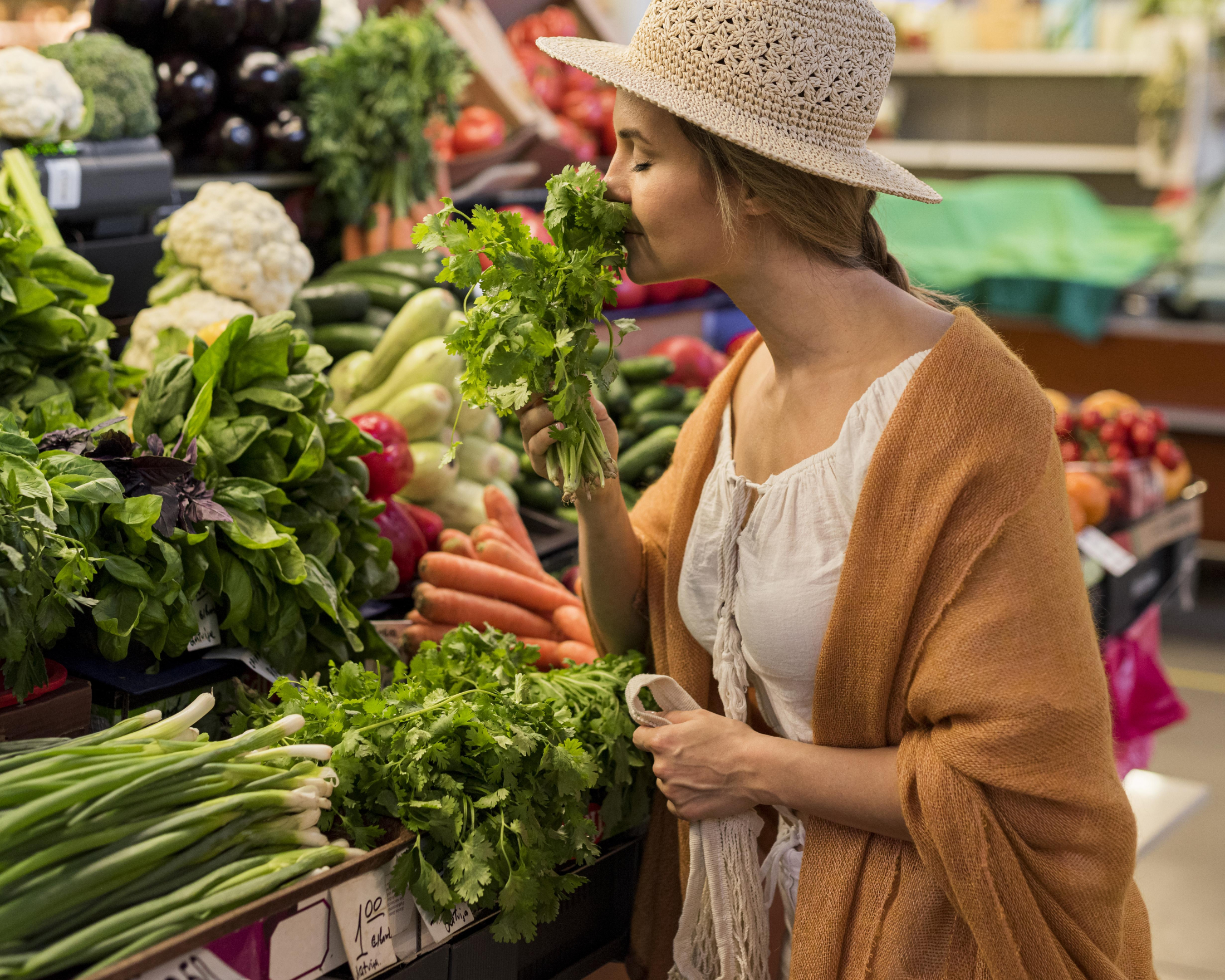 side-view-woman-wearing-sun-hat-smelling-leaves.jpg