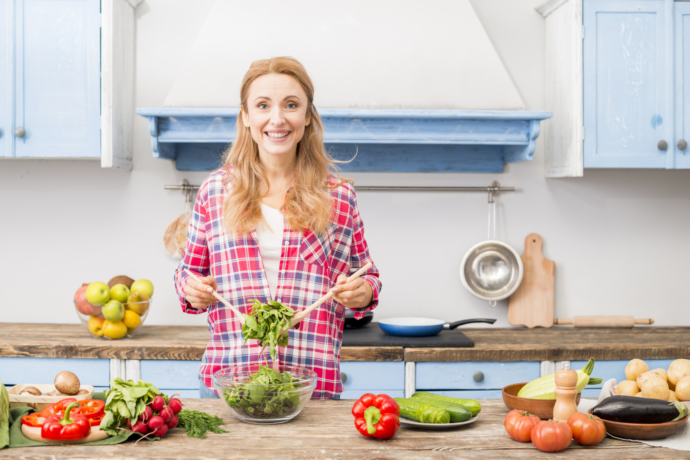 portrait-smiling-young-woman-preparing-vegetable-salad-kitchen.jpg