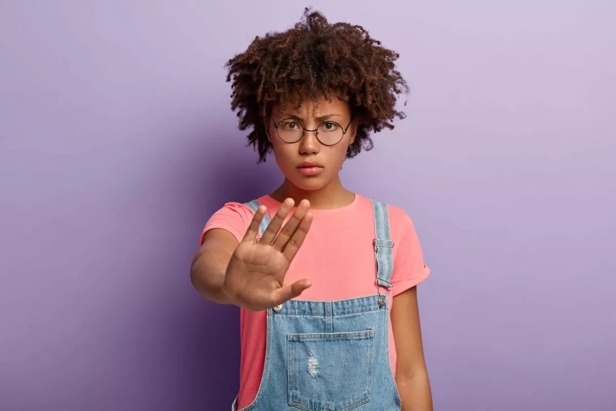 photo-of-afro-american-woman-does-stop-gesture-has-angry-facial-expression-demands-stop-talking-demonstrates-prohibition-with-no-sign-looks-angrily-though-round-spectacles.jpg